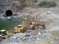 Construction trucks working on along river