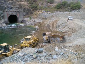 Construction trucks working on along river