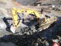 Construction excavator picking up rocks
