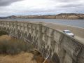 Cars driving next to dam