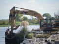 Construction excavator working on wetlands site