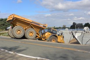 Construction dump truck working on river