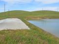 Grassy field with dam and levee