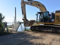Construction excavator working on river site