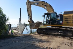 Construction excavator working on river site