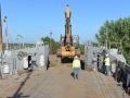 Construction worker overseeing work along river