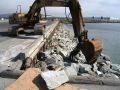 Construction excavator picking up rocks