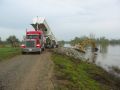 Construction trucks working on along river