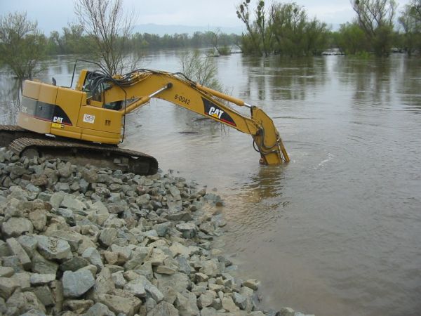 Construction excavator working in water wetlands 