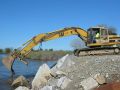 Construction excavator working on river