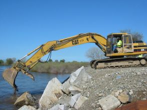 Construction excavator working on river