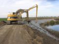 Construction excavator picking up rocks