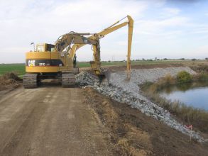 Construction excavator picking up rocks