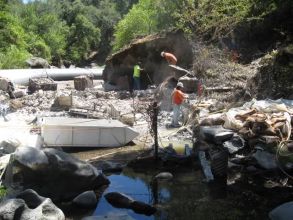 Construction workers on site of dam and levee