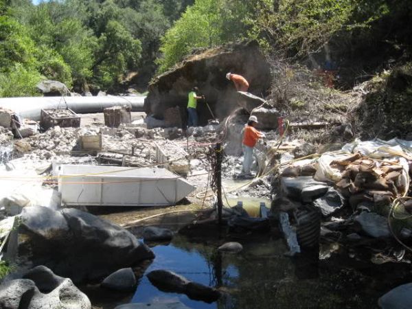 Construction workers on site of dam and levee